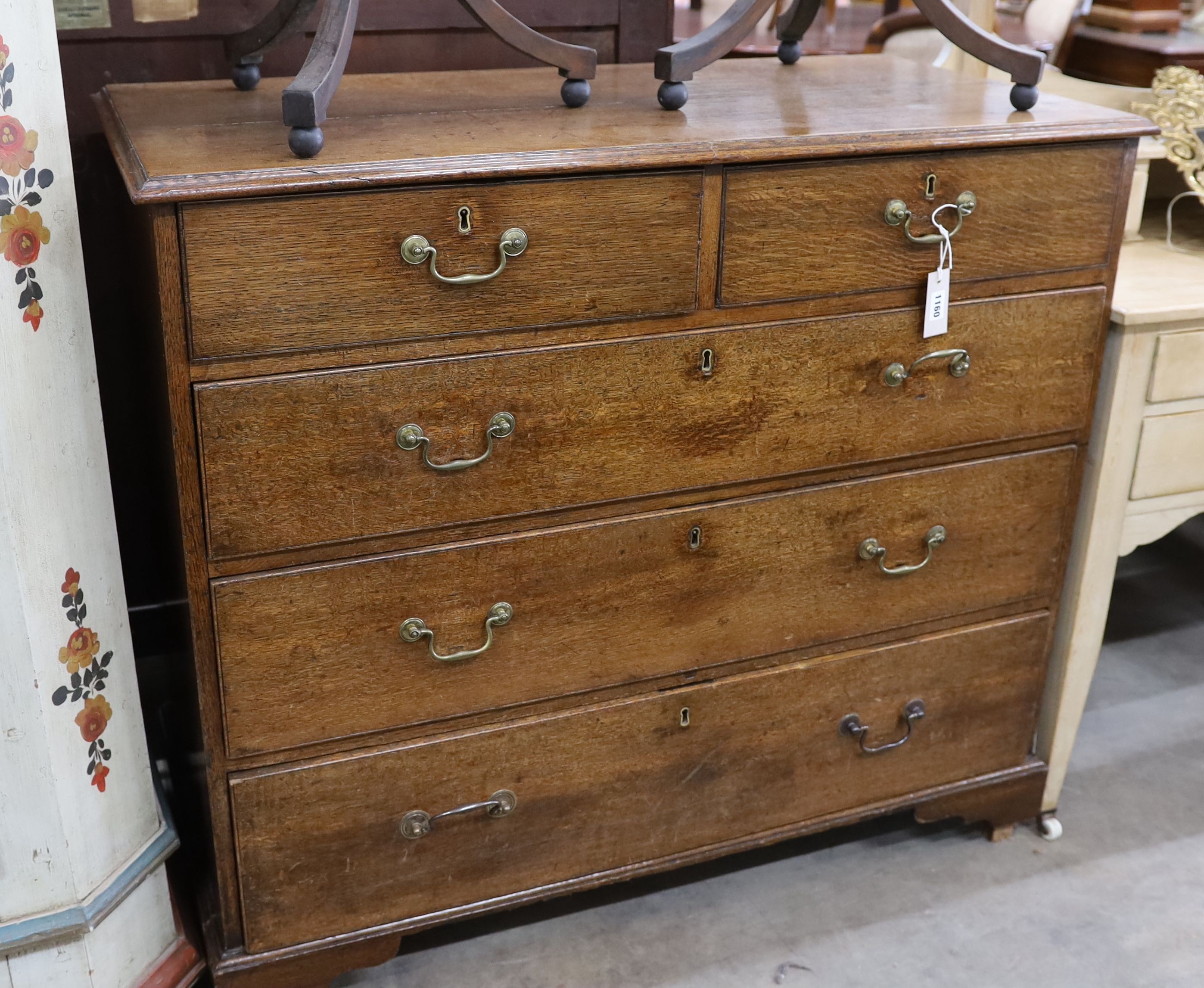 A George III provincial oak chest of two short and three long drawers, width 108cm, depth 52cm, height 98cm